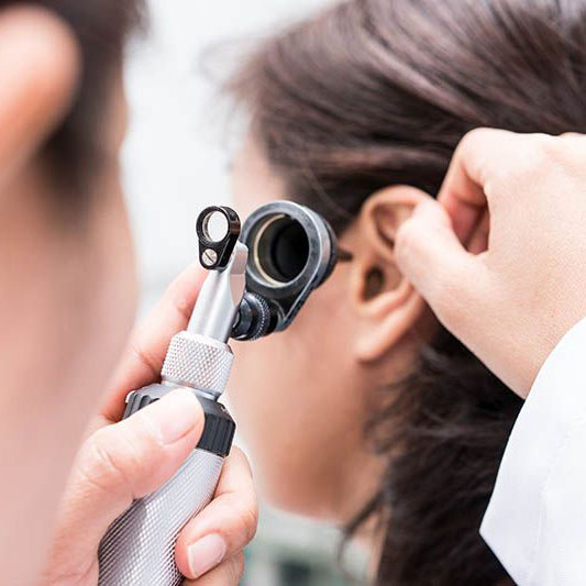examining womans ear